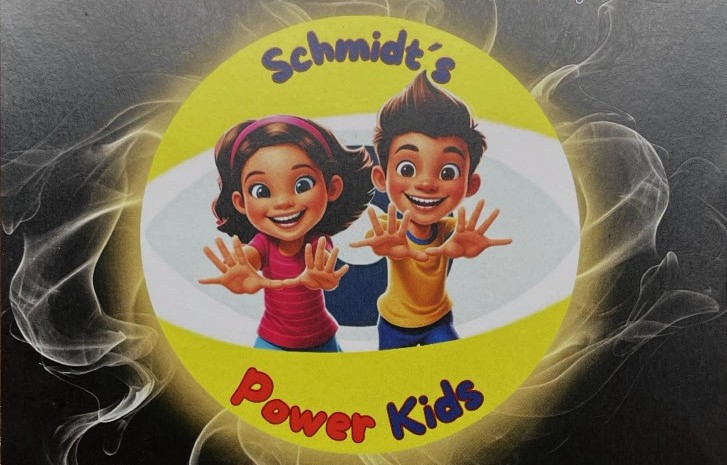 Zwei animierte Kinder, ein Mädchen und ein Junge, lächeln mit nach vorne gestreckten Händen innerhalb eines gelben Ovals mit der Aufschrift Schmidts Power Kids in blauer und roter Schrift vor einem schwarzen, rauchigen Hintergrund.
